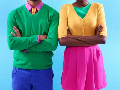 Cropped studio shot of a two stylishly dressed people standing with their arms crossed