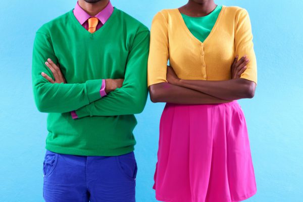 Cropped studio shot of a two stylishly dressed people standing with their arms crossed